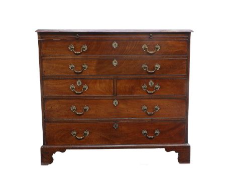 A George III Mahogany Straight-Front Chest of Drawers, the moulded hinged lid enclosing a pull-out brushing slide above an oa