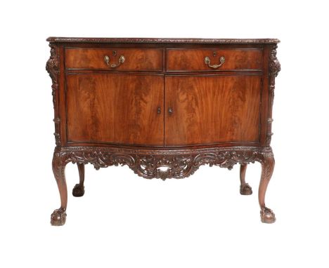 A George III Carved Mahogany Chippendale-Style Serpentine Commode, late 18th century, the moulded top with carved border abov