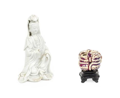 A Chinese Porcelain Figure of Guanyin, Qing Dynasty, probably Kangxi, seated wearing long flowing robes 20cm high A Chinese P