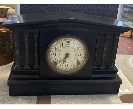 A antique wooden cased mantle clock with key and pendulum