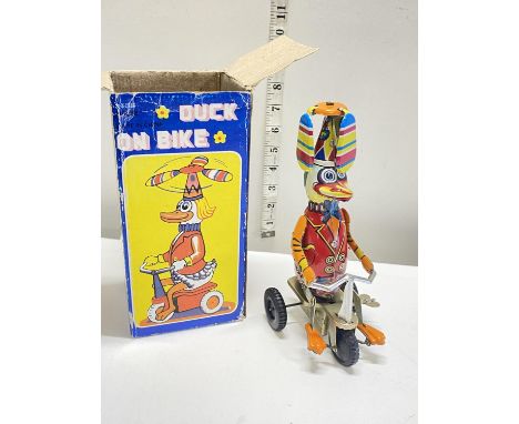 A vintage tin plate mechanical duck in original box with key