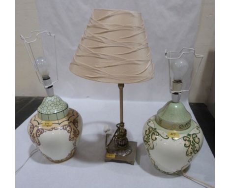 A pair of ceramic based table lamps and one other