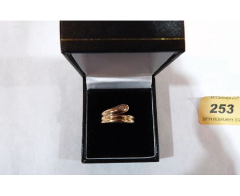 A 14ct coiled snake ring, the serpent with a diamond set eye. 2.9g. Size O