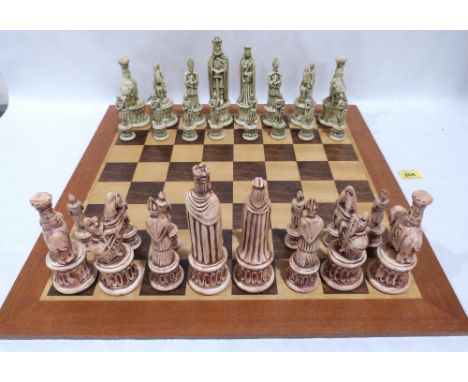 A chess set with bisque pieces and treen board 