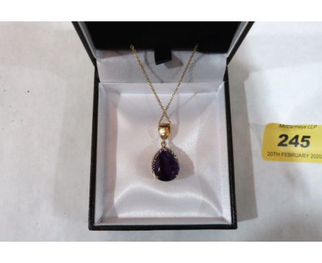 An 18ct amethyst pendant on 9ct suspension bale and chain. 6g gross