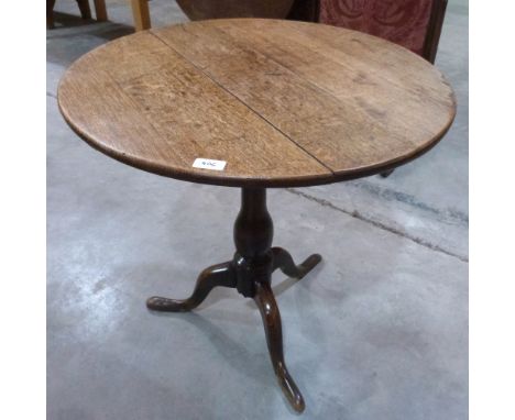 A 19th century oak tripod table on baluster turned column. 26½' diam