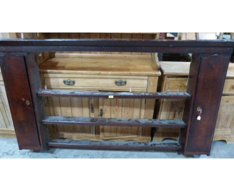 An 18th century oak dresser rack, the two cupboards enclosed by arch doors flanking three shelves. 73' wide. Prov: The Estate