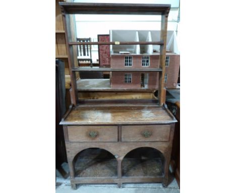 An 18th century joined oak dresser, the open rack with two shelves, over base with a pair of drawers and double arch apron, r
