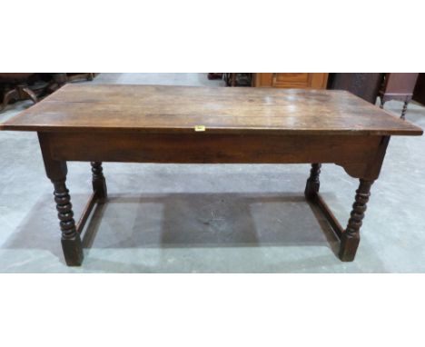 An antique oak and elm farmhouse table, the cleated plank top raised on bobbin turned supports. Elements 17th/18th century. 6