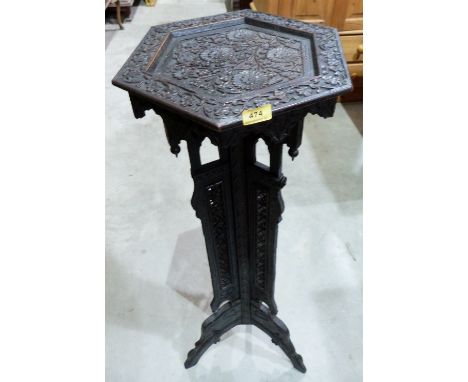 An Indian carved and pierced hardwood stand on anthropomorphic tripod support. 43½' high