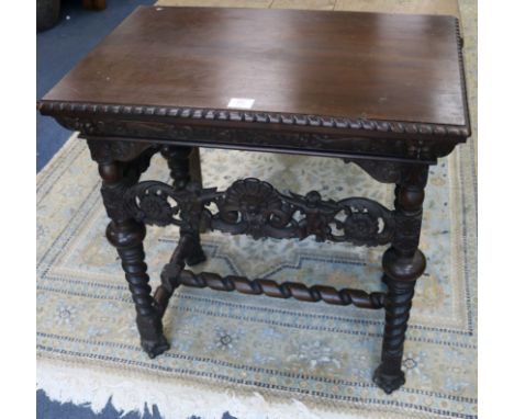 A Flemish style carved walnut side table, with carving matching the throne chair selling as Lot 970 carving matches the thron