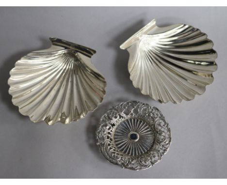 A pair of white metal butter shells and a late Victorian pierced silver nut dish.