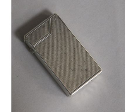 A Dunhill engine-turned silver cigarette lighter, patent no. 440072, London, 1948, 59mm.