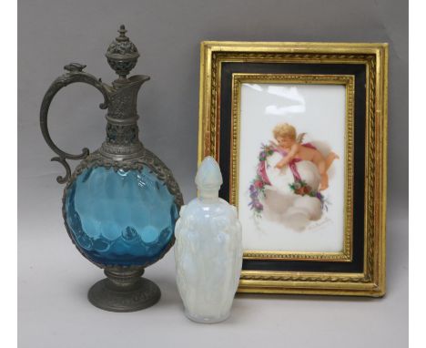 A Sabino scent bottle, a glass metal mounted ewer and a putti framed panel dated 1875