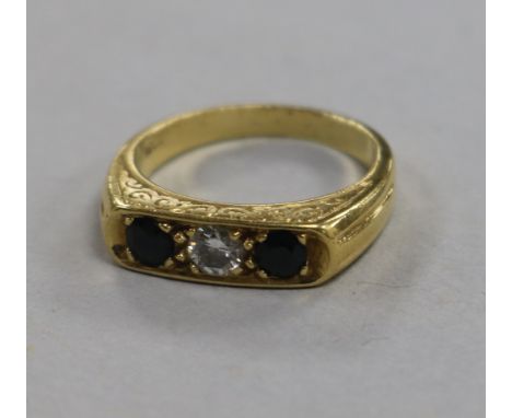 An 18ct gold and three stone sapphire and diamond ring, size O.