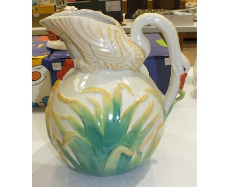 A late-19th century ceramic jug in the form of a Swan, the neck and head forming the handle and the body forming the spout, o