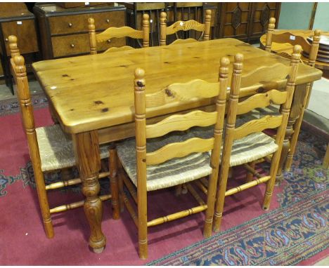 A modern pine rectangular-top kitchen table on turned legs, 141 x 83cm, a set of six pine ladder-back kitchen chairs and a mo