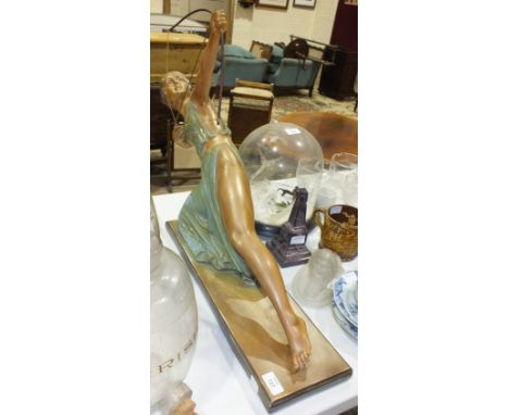 An Art Deco plaster figure of Diana The Huntress, with bow and arrow, on rectangular base, 54cm high, 54cm wide.