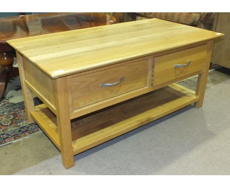 A modern light wood TV unit with two drawers and base shelf, 110cm wide, 50cm high, 59cm deep.