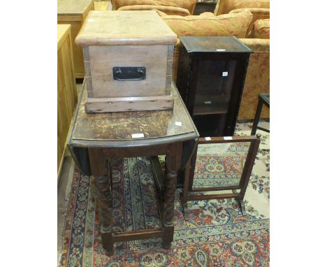 An oak gate-leg table on barley-twist supports, an oak narrow bookcase with glazed door, 31cm wide, 89cm high, a dressing gla