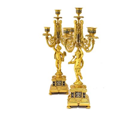 A Pair of French Gilt Metal and Champlevé Enamel Five-Light Candelabra, in Louis XVI style, with urn shape sconces and scroll