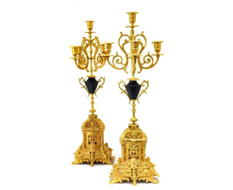 A Pair of Gilt Metal Five-Light Candelabra, in Louis XIV style, with leaf sheathed scroll branches and urn shaped sockets, on