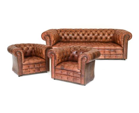 A 20th Century Brown Leather Three Piece Chesterfield Suite, comprising: a three-seater sofa with overstuffed arms and seat, 