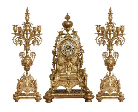 An Impressive Gilt Metal Mantel Clock Garniture, signed H.Luppens a Bruxelles, circa 1890, the elaborate case with mask and s