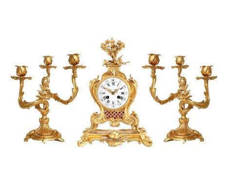An Ormolu Striking Mantel Clock Garniture, circa 1890, case surmounted with flowers, Rococo style decoration, pierced side an
