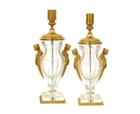 A Pair of Gilt Metal Mounted Glass Lamp Bases, in Empire style, of panelled baluster form with caryatid handles, on stepped s