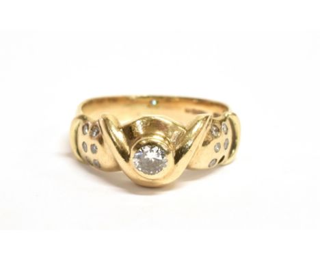 A 9CT GOLD DIAMOND DRESS RING  the ring set with central round cut diamond measuring approx. 0.25cm in diameter with white st