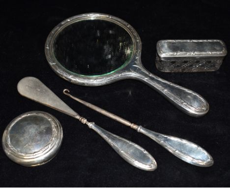 A GEORGE V SILVER DRESSING TABLE SET  Comprising hand held mirror, silver top cut glass rectangular jar, silver handled shoe 