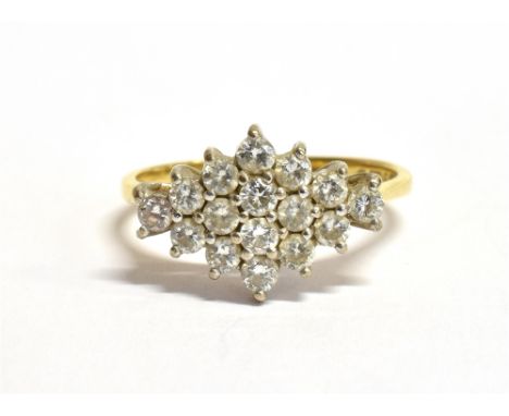 AN 18CT GOLD DIAMOND PLAQUE RING The plaque set with 15 small round cut diamonds each measuring 0.2cm in a white metal bed on