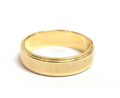 A STAMPED 750 YELLOW METAL BAND RING  the ring with textured pattern with shank marked 750 A1, ring size M, weight 4.6grams a