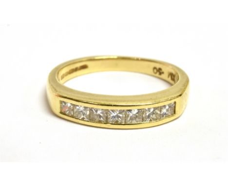 AN 18ct GOLD CALIBRÉ CUT DIAMOND HALF BAND RING The seven diamonds each measuring 0.2cm approx on a tapered gold band with sh