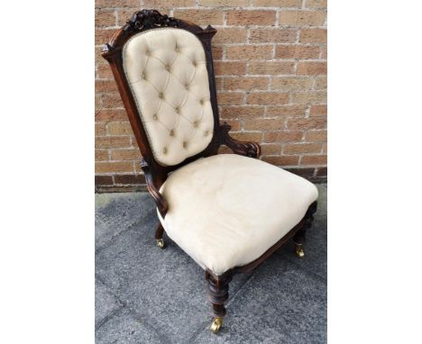 AN EDWARDIAN CARVED WALNUT BUTTON UPHOLSTERED SALON CHAIR  on brass casters Condition Report : re-upholstered. some old worm 