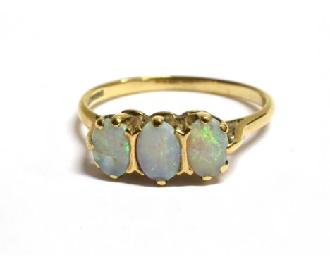 A 9CT GOLD OPAL TRIPLE STONE DRESS RING the ring with faded marks, opal measurement 0.6 x 0.4cm approx., ring size O 1/2 , we