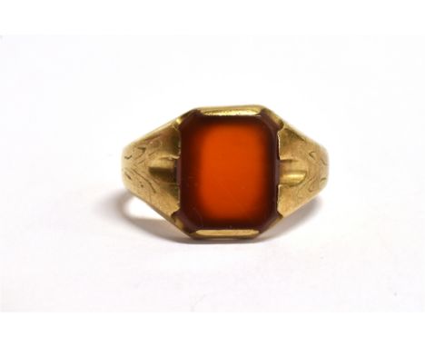 A GOLD SIGNET RING the bezel of a rectangular red hard stone setting, hallmarked for Birmingham 1975, ring size R, weight 5.5