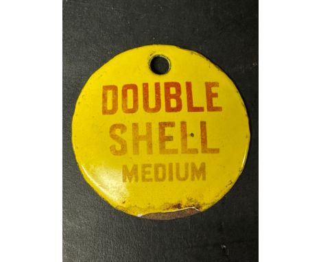 A small circular enamel brand tag for Double Shell Medium, 2 3/4" diameter.