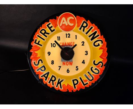 An unusual A.C. Fire Ring Spark Plugs light-up advertising wall clock, 16 1/2" diameter. 