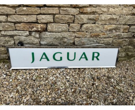 A Jaguar dealership light-up advertising sign with acrylic panel in metal box, 49 x 10 1/2, 6" depth.