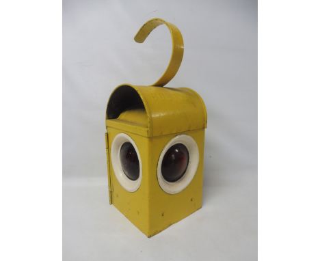 A tin roadside warning light with glass lenses and internal burner. 