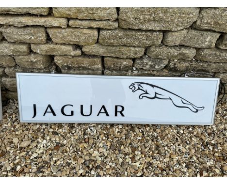 A contemporary Jaguar light up sign with black vinyl lettering on white panel, 48 3/4 x 13".