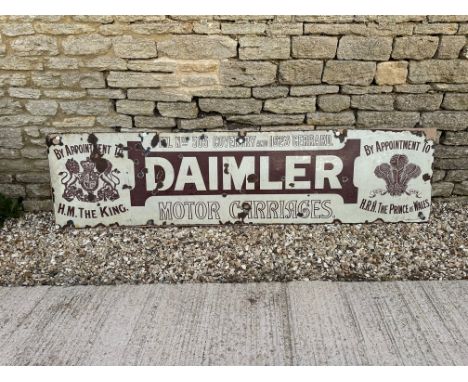 A rare Daimler Motor Carriages enamel advertising sign with Royal warrants to either end, by Chromo of Wolverhampton, mounted