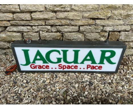 A contemporary Jaguar light up sign with green lettering on white panel, 39 3/4 x 13 3/4".