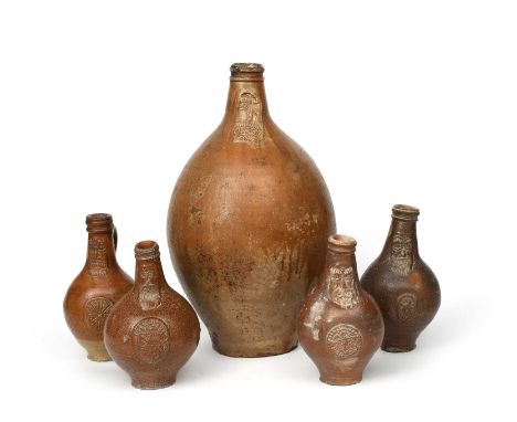A tall salt-glaze stoneware Bellarmine jar, swollen form, the narrow neck incised with bearded face, and four others smaller,