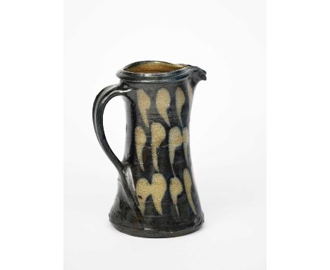 Shoji Hamada (1894-1978)a stoneware jug, waisted form with applied strap handle, painted in resist with three bands of leaf m