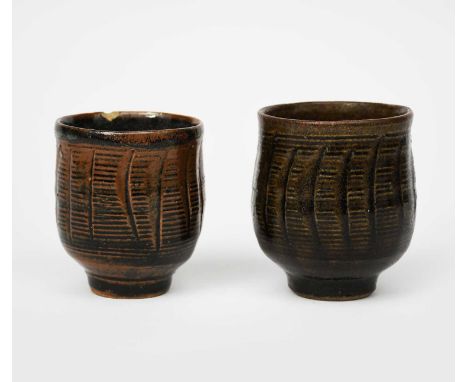 Atsuya Hamada (1932-1986)a stoneware unomi, footed form with incised vertical ribs, glazed dark iron, and another similar,uns