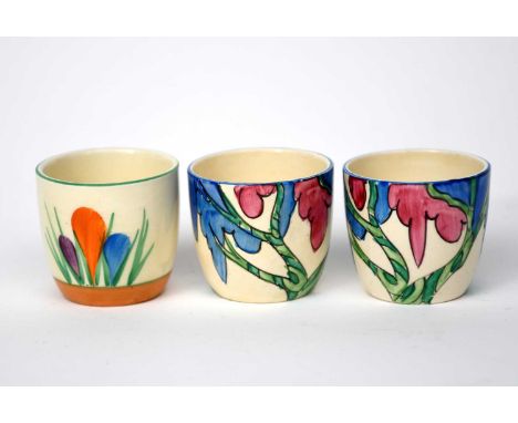 'Rudyard' two Clarice Cliff Fantasque Bizarre egg cups, painted in colours, and Clarice Cliff 'Crocus' egg cup, printed facto