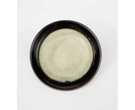 Richard Batterham (1936-2021)a large stoneware fruit dish, ash glaze, with white slip, the rim black iron,unsigned40.5cm. dia